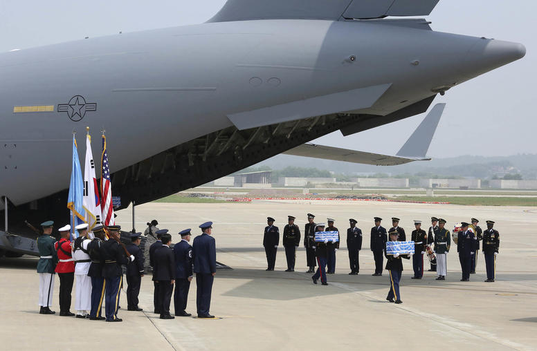 An honor guard greets the arrival of remains returned by North Korea, believed to belong to 55 U.S. servicemen, at the Osan Air Base in Pyeongtaek, South Korea, July 27, 2018. (Ahn Young-joon/Pool via The New York Times)