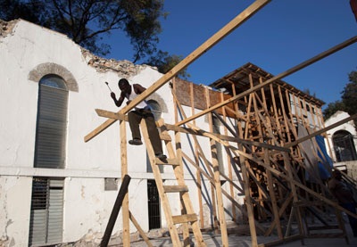A man rebuilds a church in Haiti (NYTimes Photo)