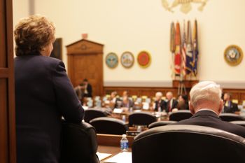 Former Rep. Ellen O. Tauscher and James R. Schlesinger talk in the House Armed Services Committee hearing room. (Credit: USIP Photo/Keith Mellnick)