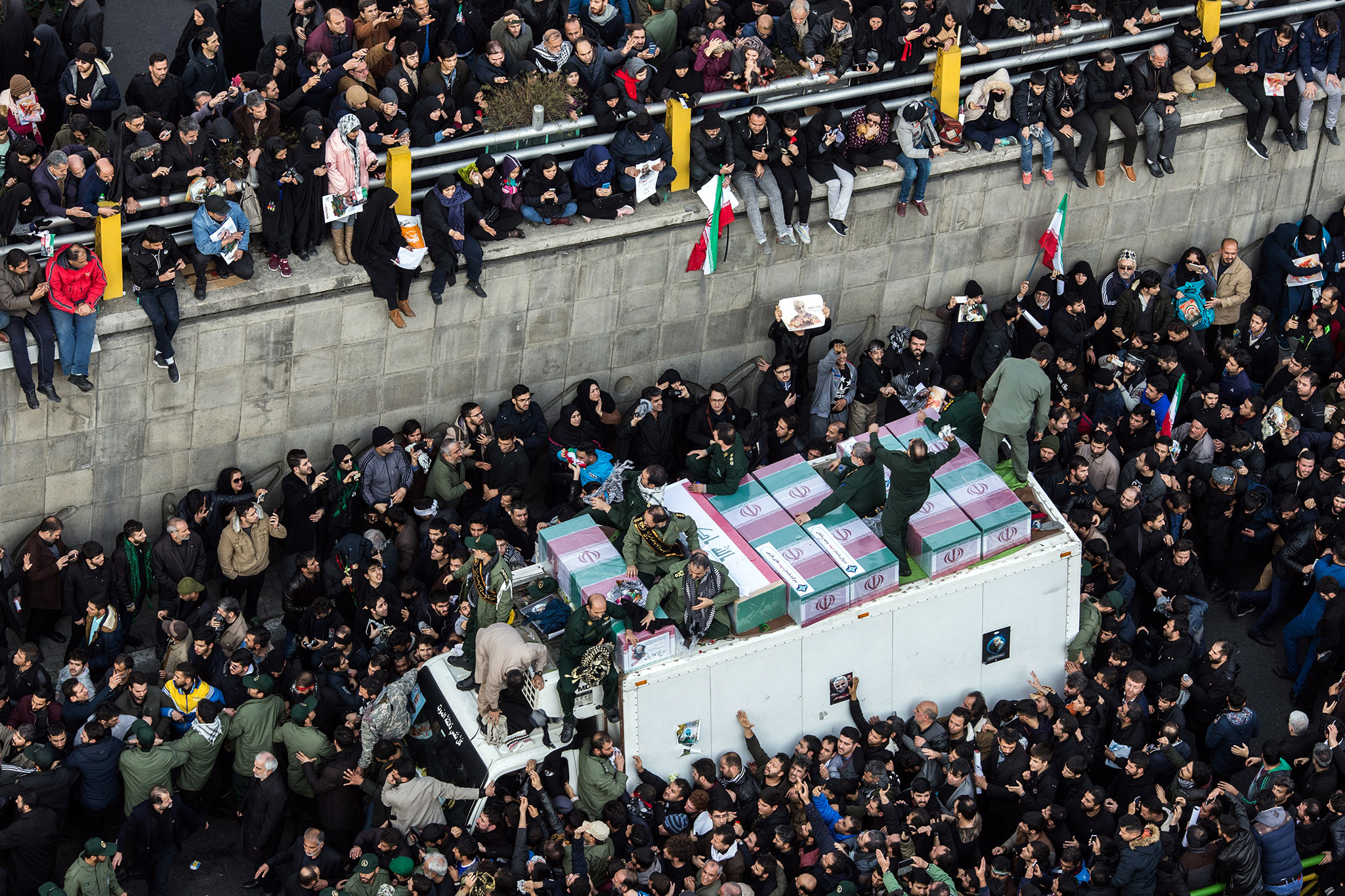 The coffins of Maj. Gen. Qassem Soleimani and others are carried on a truck through Tehran during a funeral procession on Monday, Jan. 6, 2019. (Arash Khamooshi/The New York Times)