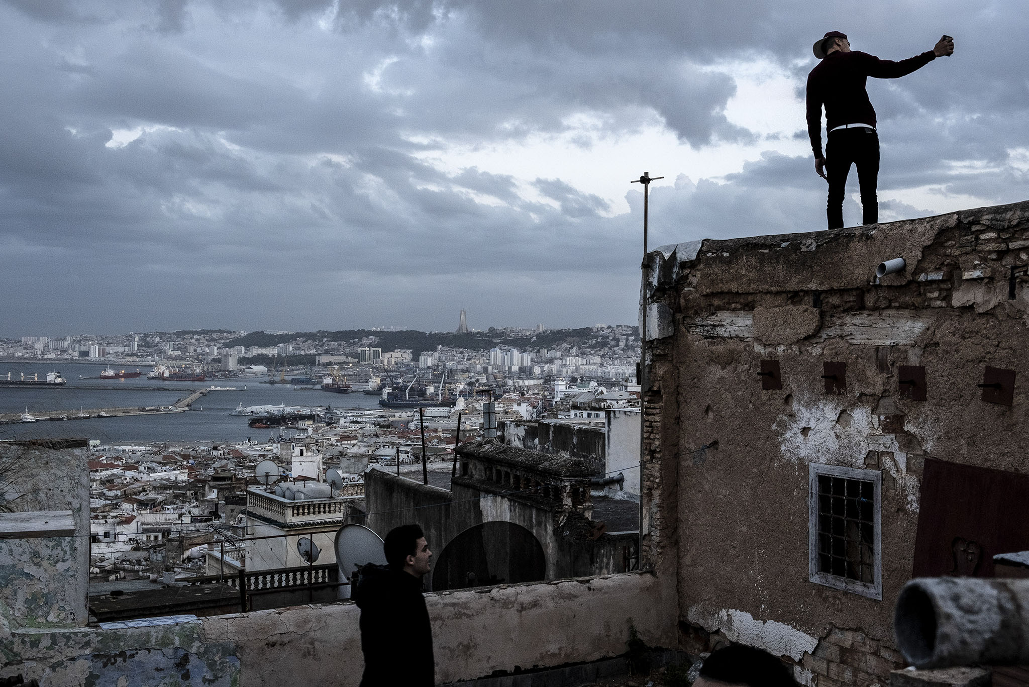 Young men gather on the roof of a home in the Casbah district of Algiers, April 6, 2019. (Ferhat Bouda/The New York Times)