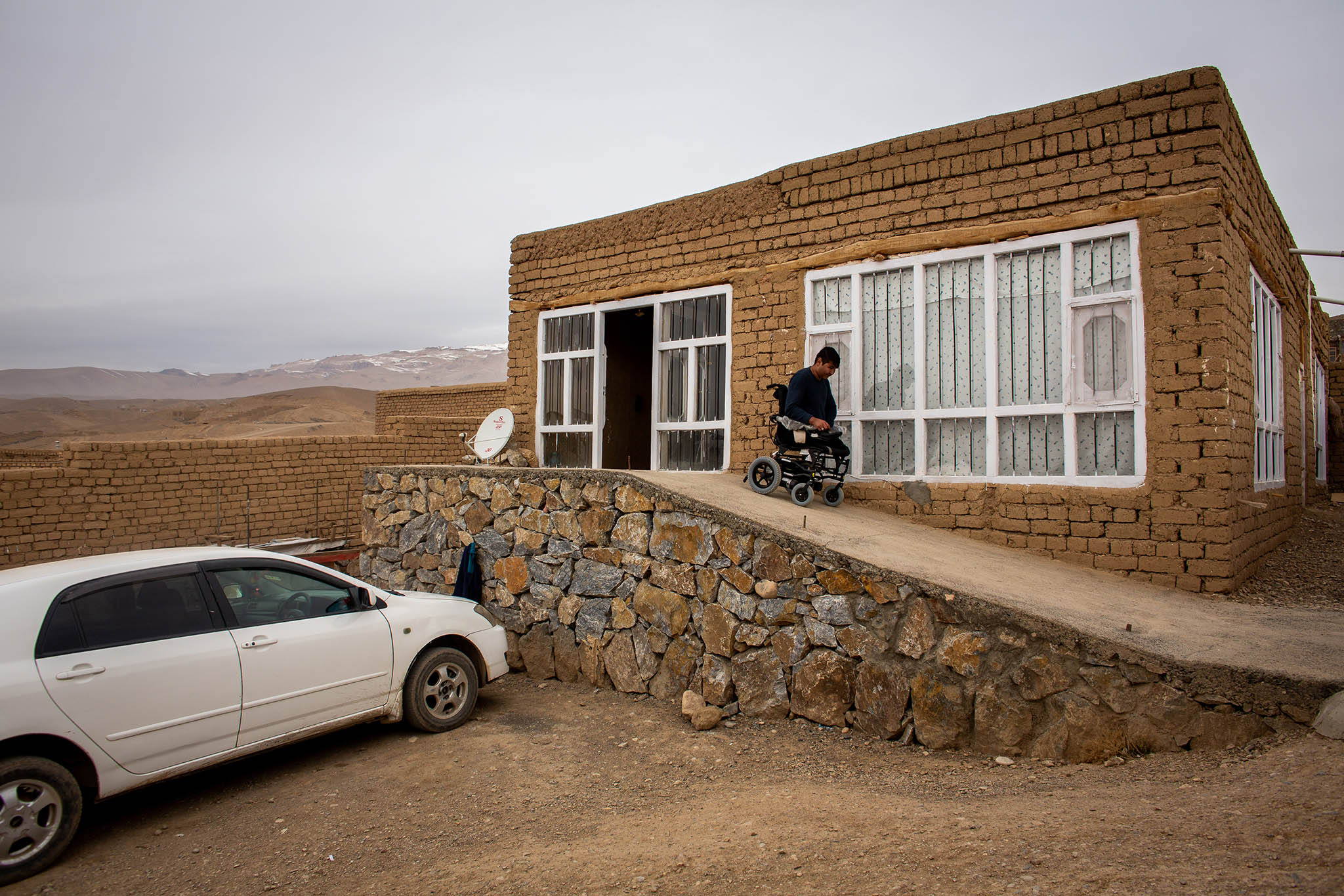 Mirza Hussain Haidari uses a wheelchair-accessible entrance at his home in Bamian, Afghanistan, November 19, 2019. (Jim Huylebroek/The New York Times)