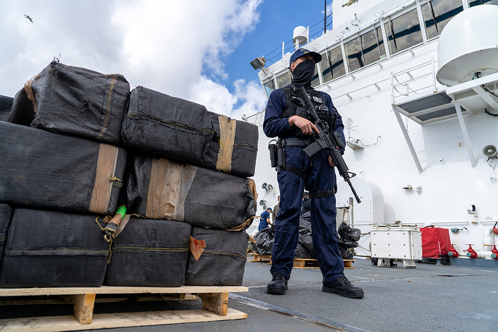 The crew of the Coast Guard Cutter Bertholf offloads approximately 7,500 pounds of seized cocaine and marijuana in San Diego. March 20, 2021. (Travis Magee/U.S. Coast Guard)