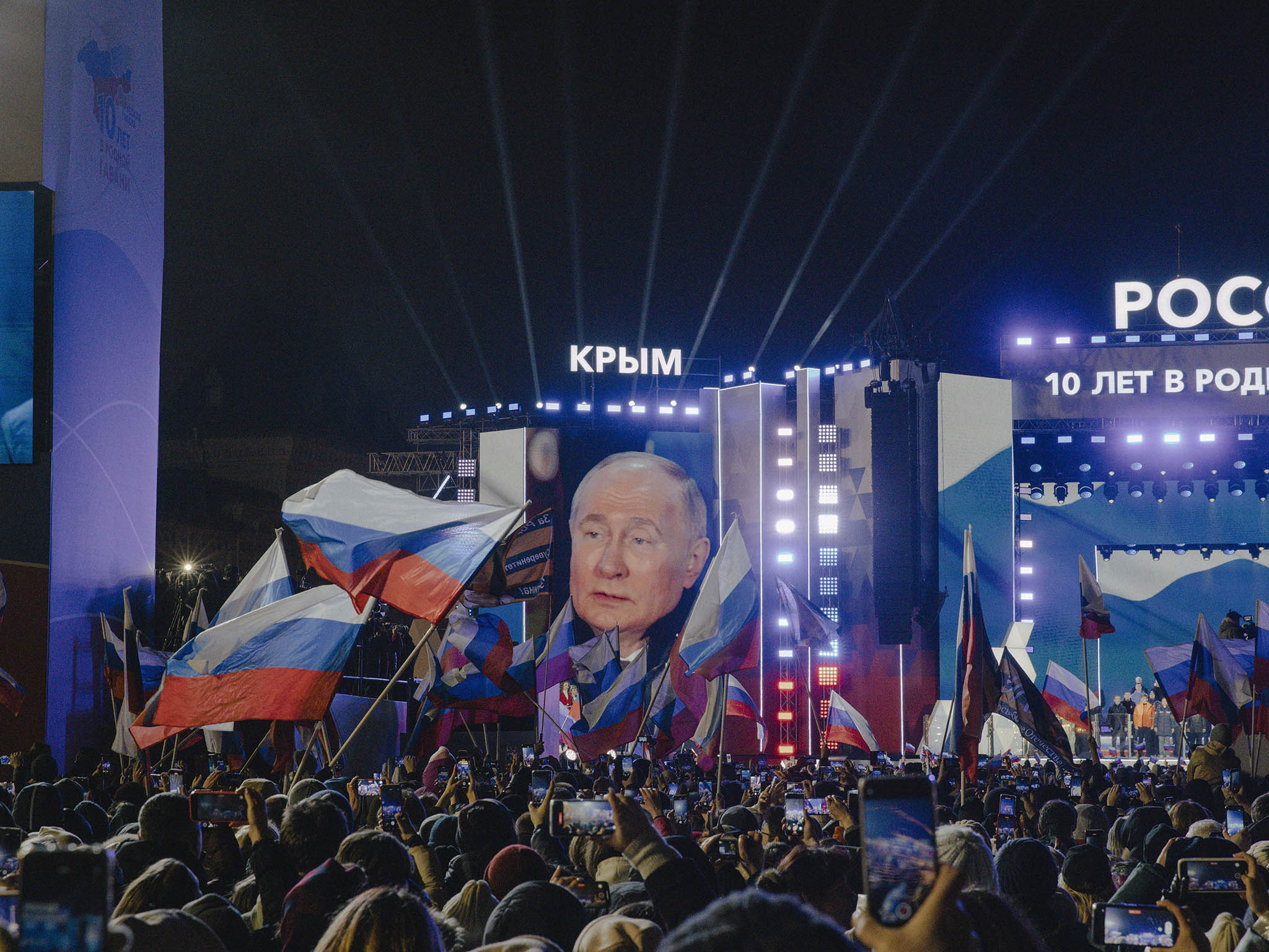 A screen displays Russian President Vladimir Putin as he speaks at an event marking the 10th anniversary of Russia’s illegal annexation of Crimea from Ukraine on Red Square in Moscow, March 18, 2024. (Nanna Heitmann/The New York Times)