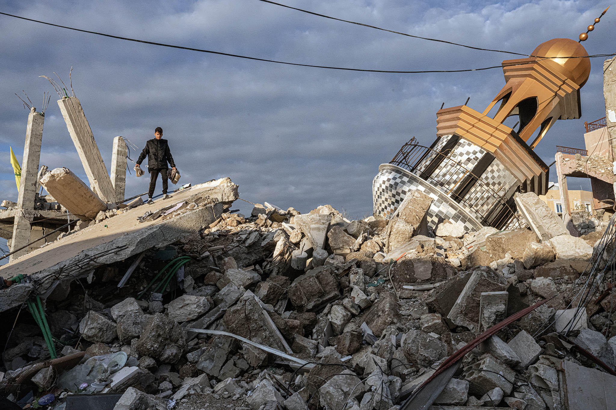 A boy walks over the rubble of a damaged mosque in Tyre, Lebanon, on Thursday, Nov. 28, 2024. (Daniel Berehulak/The New York Times)