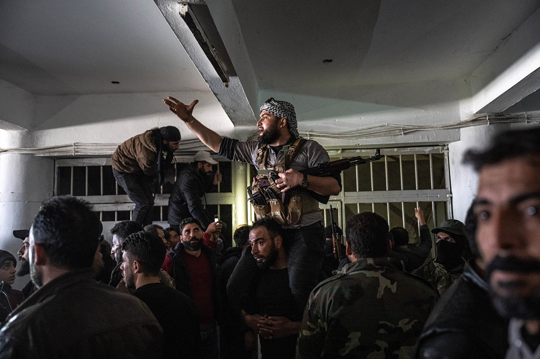 Syrian rebels try to maintain order as people enter the infamous Sednaya prison, on the outskirts of Damascus, Syria, on Monday, Dec. 9, 2024. (Daniel Berehulak /The New York Times)