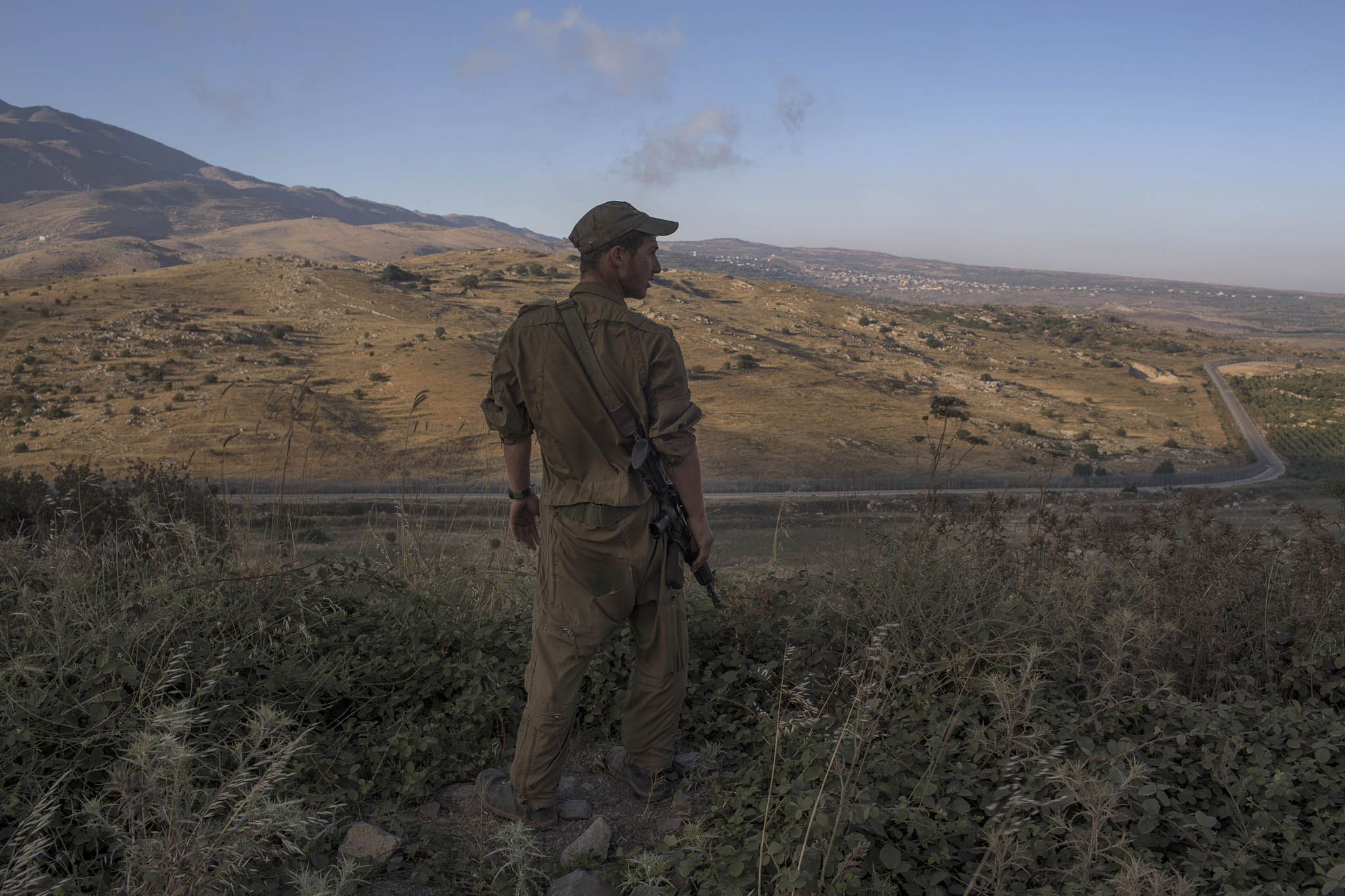 An Israeli soldier stands near the border with Syria in the Golan Heights, June 21, 2015. (Uriel Sinai/The New York Times)