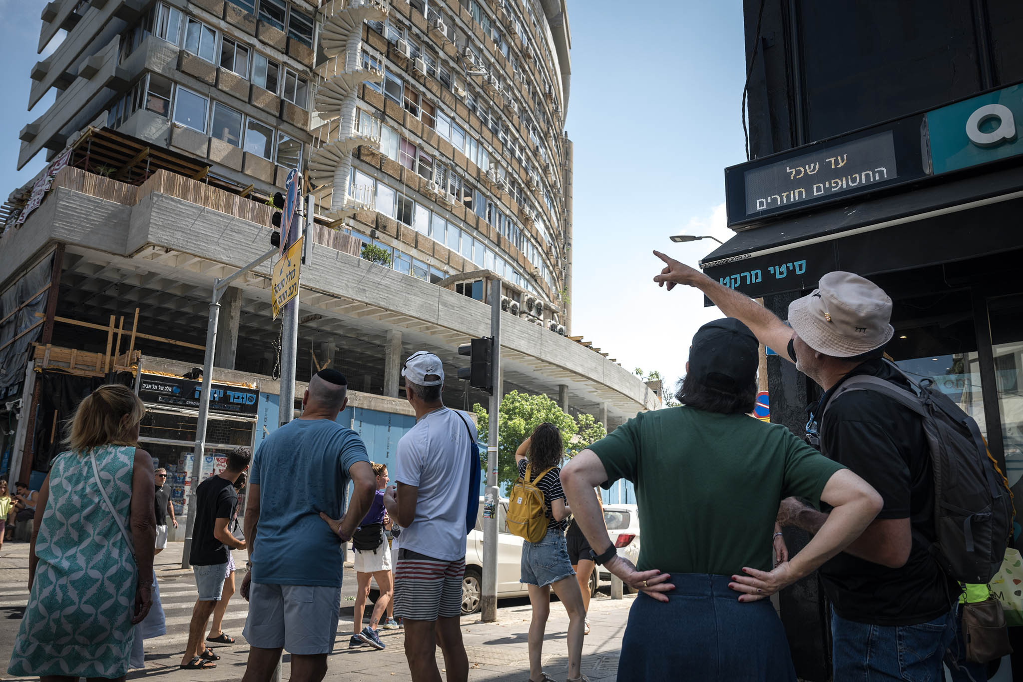 People gather near the scene of a Houthi drone strike in Tel Aviv, Israel on Friday, July 19, 2024. (Sergey Ponomarev/The New York Times)