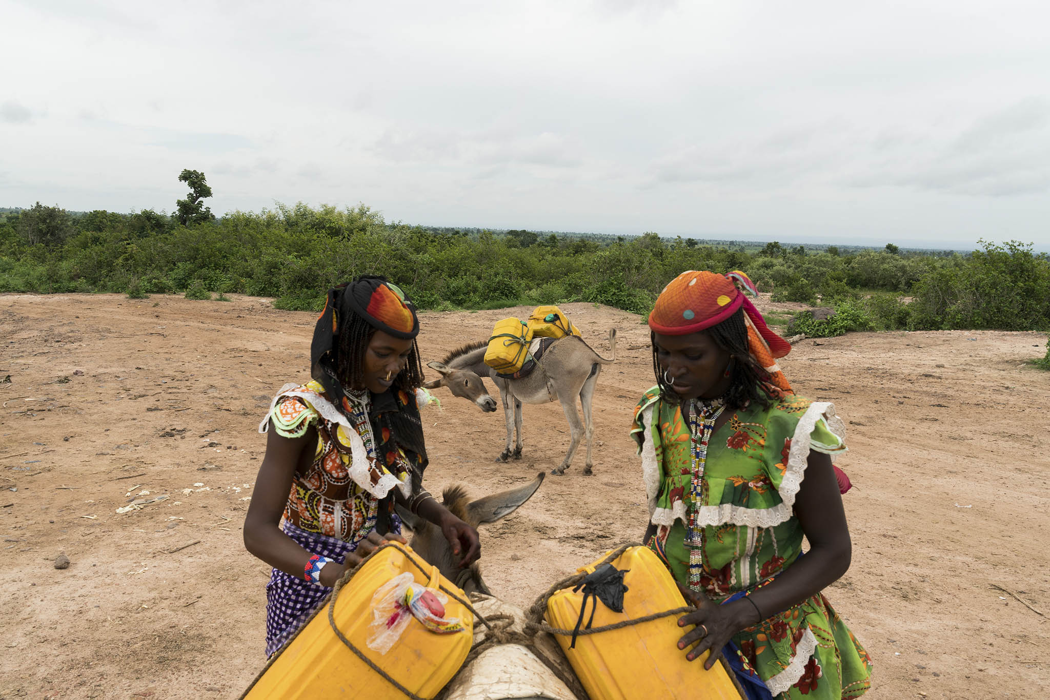 Women load water onto donkeys outside of Garin, Nigeria. September 3, 2018. Conflicts between farmers and herdsmen vying for land have increased in the region. (Adriane Ohanesian/The New York Times)