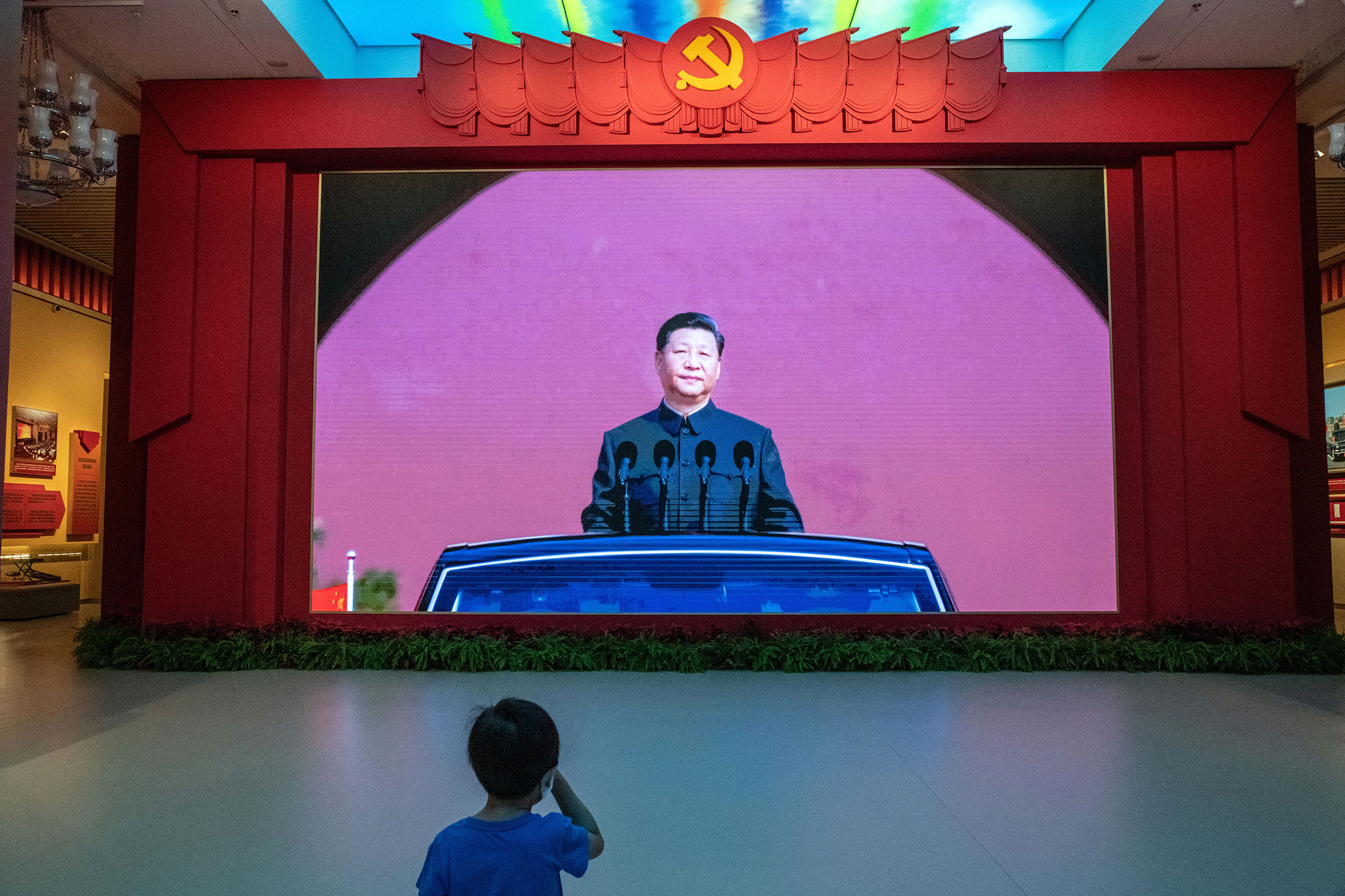 A boy views a video depicting Chinese leader Xi Jinping at the Military Museum in Beijing on Sept. 2, 2022. (Gilles Sabrié/The New York Times)