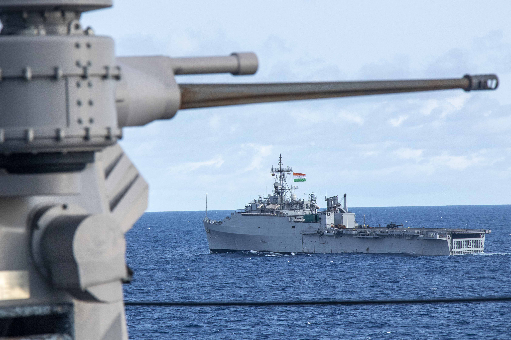 An Indian Navy amphibious transport dock sails alongside the Whidbey Island-class dock landing ship USS Comstock (LSD 45) in the Bay of Bengal during Tiger Triumph 2025, April 8. (U.S. Navy/Chief Mass Communication Specialist Leonard Adams)