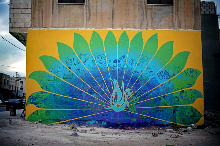 In the Jordanian town of Mafraq tensions have flared between local residents and Syrian refugees. Jordanian and Syrian youth used a workshops on conflict resolution to paint messages urging coexistence on the blank wall of a local building. The mural, in the form of a colorful peacock, was initially defaced, but dialogues between Jordanian and Syrian communities have helped it to stay intact. Photo: aptART