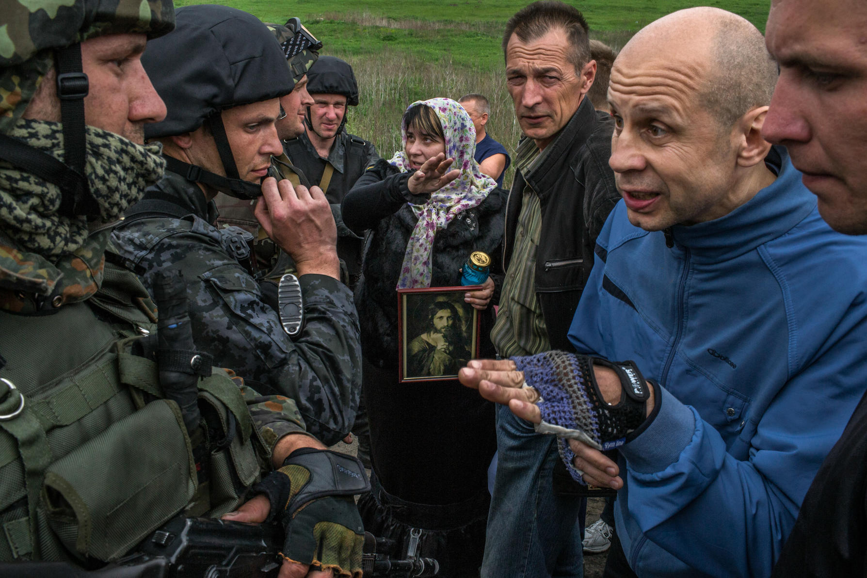 A pro-Russia villager argues with Ukrainian soldiers after troops were being blocked by villagers at a checkpoint in Slovyansk, Ukraine, May 2, 2014