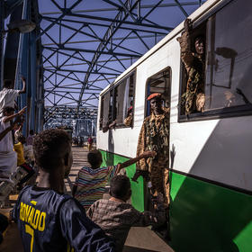 Protesters cheer as a bus carrying solders is driven over a bridge near the site of a sit-in outside military headquarters in Khartoum, Sudan. Tuesday, April 23, 2019. (Bryan Denton/The New York Times)