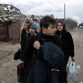 Ukrainians leave home in the village of Ternovka, southern Ukraine, March 8 after it was struck by Russian forces. War crimes investigators are gathering details on the pattern of Russian attacks on civilian targets. (Tyler Hicks/The New York Times)