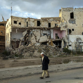 A man walks past the ruins left by years of conflict in the historic center of Benghazi, Libya, on Jan. 20, 2020. (Ivor Prickett/The New York Times)