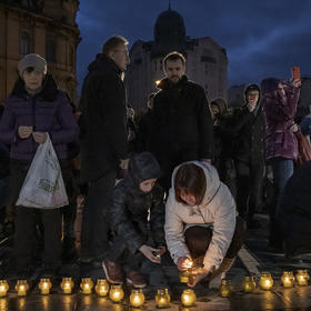 People light candles at a vigil for civilians killed in Bucha and in the surrounding area when occupied by Russian forces, in Lviv, Ukraine, on Tuesday, April 5, 2022. (Mauricio Lima/The New York Times)