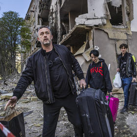 A Ukrainian family rescues belongings from their home, shattered by one of several Russian missiles that struck Kyiv as U.N. Secretary-General Antonio Guterres visited the city and held talks with the government. (David Guttenfelder/The New York Times)