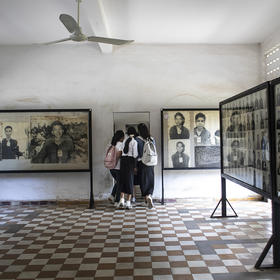 Students make their way through photo displays at the Tuol Sleng Genocide Museum in Phnom Penh, Cambodia, on Saturday, Jan. 22, 2022. (Nadia Shira Cohen/The New York Times)