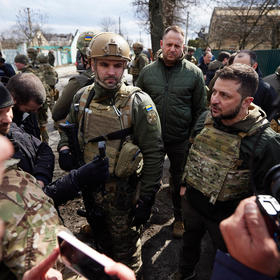 Ukrainian President Volodymyr Zelenskyy, center right, meets residents of Bucha, near Kyiv, after Russian troops’ killing of civilians there in March. Ukrainians polled express strong support for his stance on the war. (Ukraine Presidential Office)