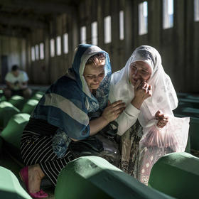Relatives of victims of the Srebrenica massacre mourn in Potocari, Bosnia, prior to the reburial of the remains. (Andrew Testa/The New York Times).