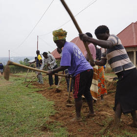 Residents work together on a drainage ditch in Mbyo, one of seven "reconciliation villages” where perpetrators and victims of the genocide in Rwanda live side by side, in April 2017. (Megan Specia/The New York Times)