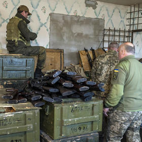 Military volunteers load magazines with ammunition on Feb. 25, 2022, at a weapons storage facility in Fastiv, Ukraine. war. (Brendan Hoffman/The New York Times)