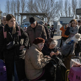 Ukrainians fleeing Russia’s new invasion wait for buses after crossing into Moldova in March. Moldova, Europe’s poorest country, hosts 85,000 refugees — and the entire population faces power and heat outages this winter. (Mauricio Lima/The New York Times)