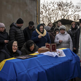 Family members in Kyiv mourn their 26-year-old son, a Ukrainian soldier killed in a Russian attack last month. At points in the past year, government officials say, the war has killed 100 to 200 Ukrainian soldiers each day. (Nicole Tung /New York Times)