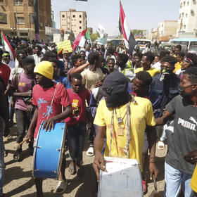 Sudanese march in the city of Omdurman last March as civilians anticipated a deadline for top generals to hand power to a civilian government. But the generals kept power — and instead went to war days later. (Faiz Abubakar Muhammed/The New York Times)