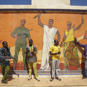 Men gather at Burkina Faso’s independence monument in the capital to show support for a coup d’état in January 2022. This summer’s coup in neighboring Niger expands the zone of army rule in the Sahel region. (Malin Fezehai/The New York Times)