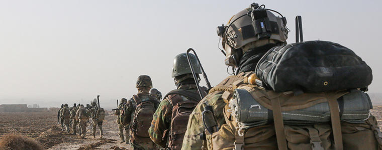 A U.S. Special Forces Soldier with Combined Joint Special Operations Task Force-Afghanistan and Afghan National Army Commandos with the 3rd Company, 3rd Special Operations Kandak move toward a compound during a clearance operation in Bahlozi, Maiwand district, Kandahar province, Afghanistan, Jan. 1, 2014. (DoD photo by Staff Sgt. Bertha A. Flores, U.S. Army/Released)