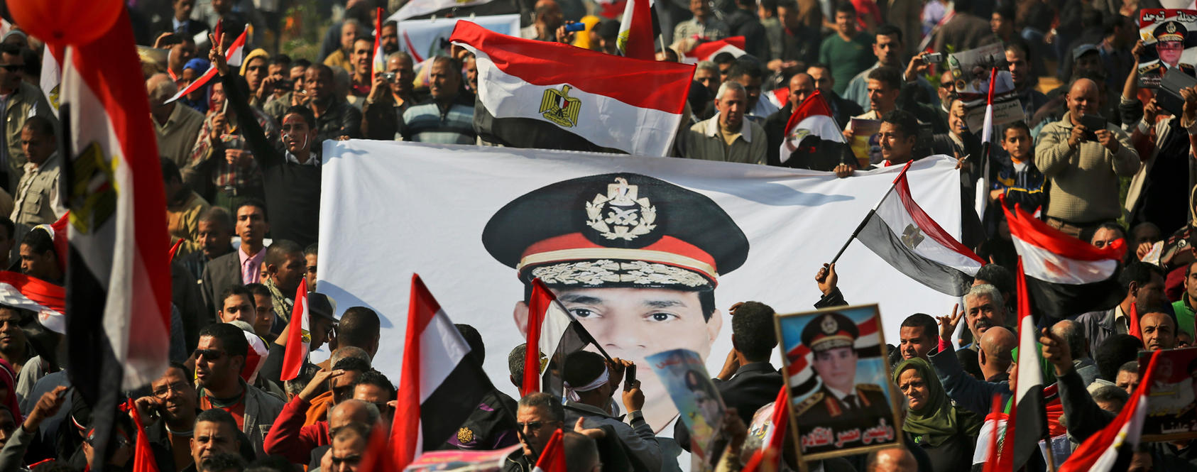 Supporters of the military wave national flags and hold posters and banners of Gen. Abdel-Fattah el-Sissi in Cairo's Tahrir Square, Jan. 25, 2014. The senior leaders of the Egyptian military have authorized el-Sissi to run for president, state television reported Monday, making it nearly certain that he would seek the post.