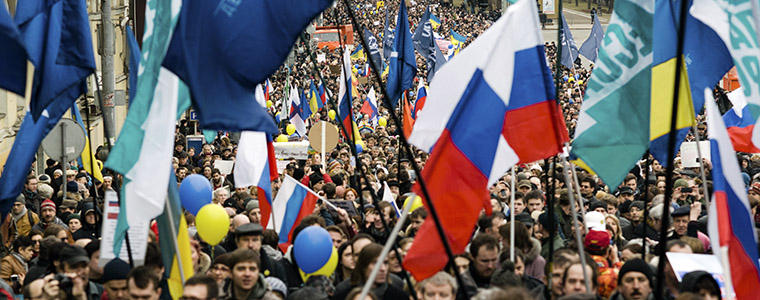 Demonstrators wave flags and banners during a "March for Peace" rally opposing President Vladimir Putin and war in Ukraine, in Moscow, March 15, 2014.