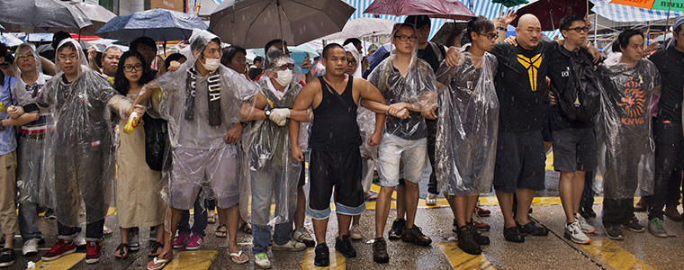 Pro-democracy protesters stand in a formation after coming under assault in the Mong Kok neighborhood of Hong Kong, Oct. 3, 2014. Photo Credit: The New York Times/Adam Ferguson