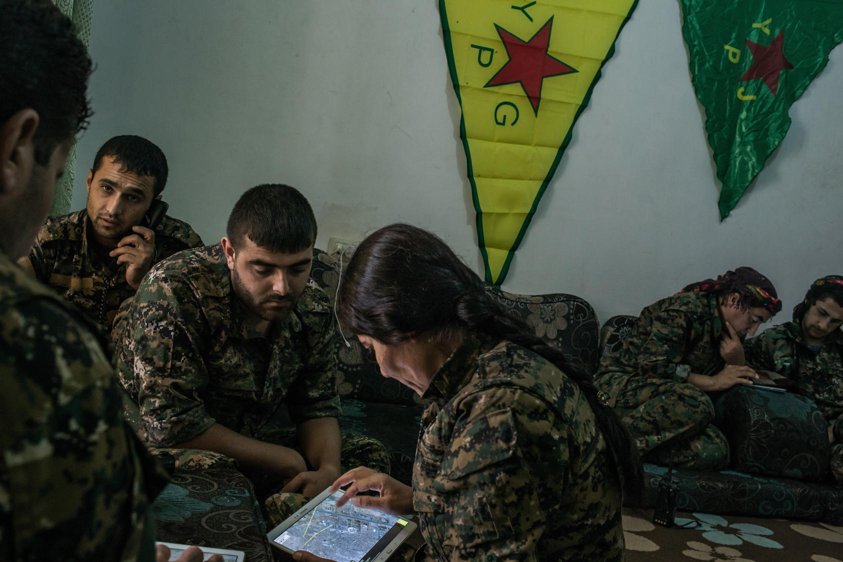 Kurdish Y.P.G. fighters inspect maps and check locations as they coordinate an airstrike with the U.S. against an ISIS position, Hasaka, Syria, July 31, 2015. The Y.P.G. has been one of the few groups to constantly and effectively battle ISIS in Syria. (Mauricio Lima/The New York Times)