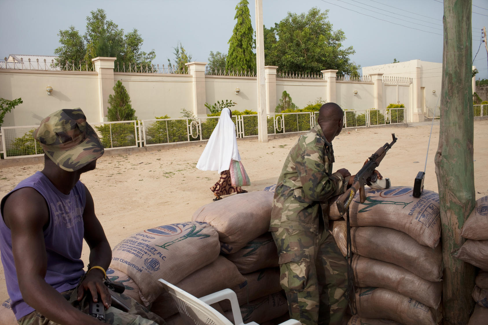 Nigerian soldiers survey passing civilians in the government reserved area of Maiduguri, in north-eastern Nigeria, July 19, 2011. Photo Credit: The New York Times/Samuel James