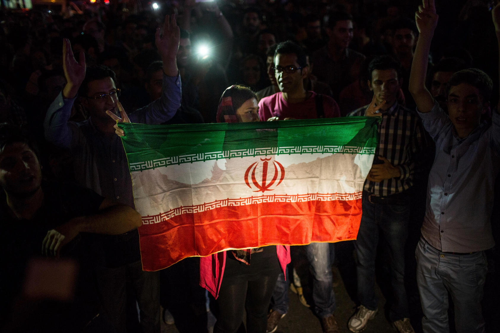 Iranians holding their flag celebrate the announcement that Iran had reached a nuclear deal with world powers in Tehran, Iran, July 14, 2015. Iran and a group of six nations led by the U.S. said they had reached a historic accord on Tuesday to significantly limit Tehran’s nuclear ability for more than a decade in return for lifting international oil and financial sanctions.