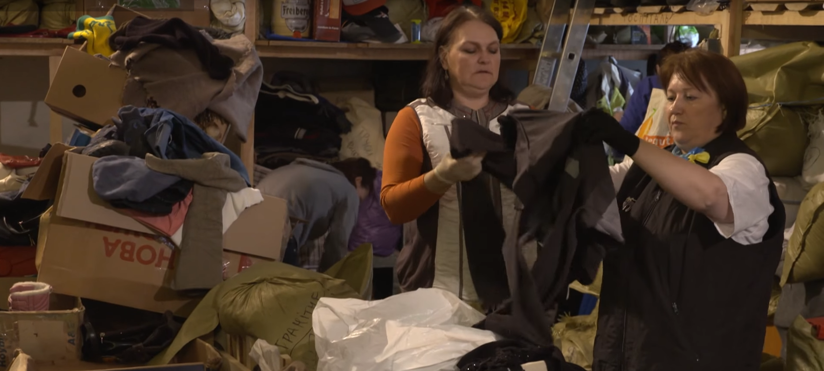 Ukrainian volunteers sort donated goods for displaced citizens. (Photo: UNHCR video screenshot)  