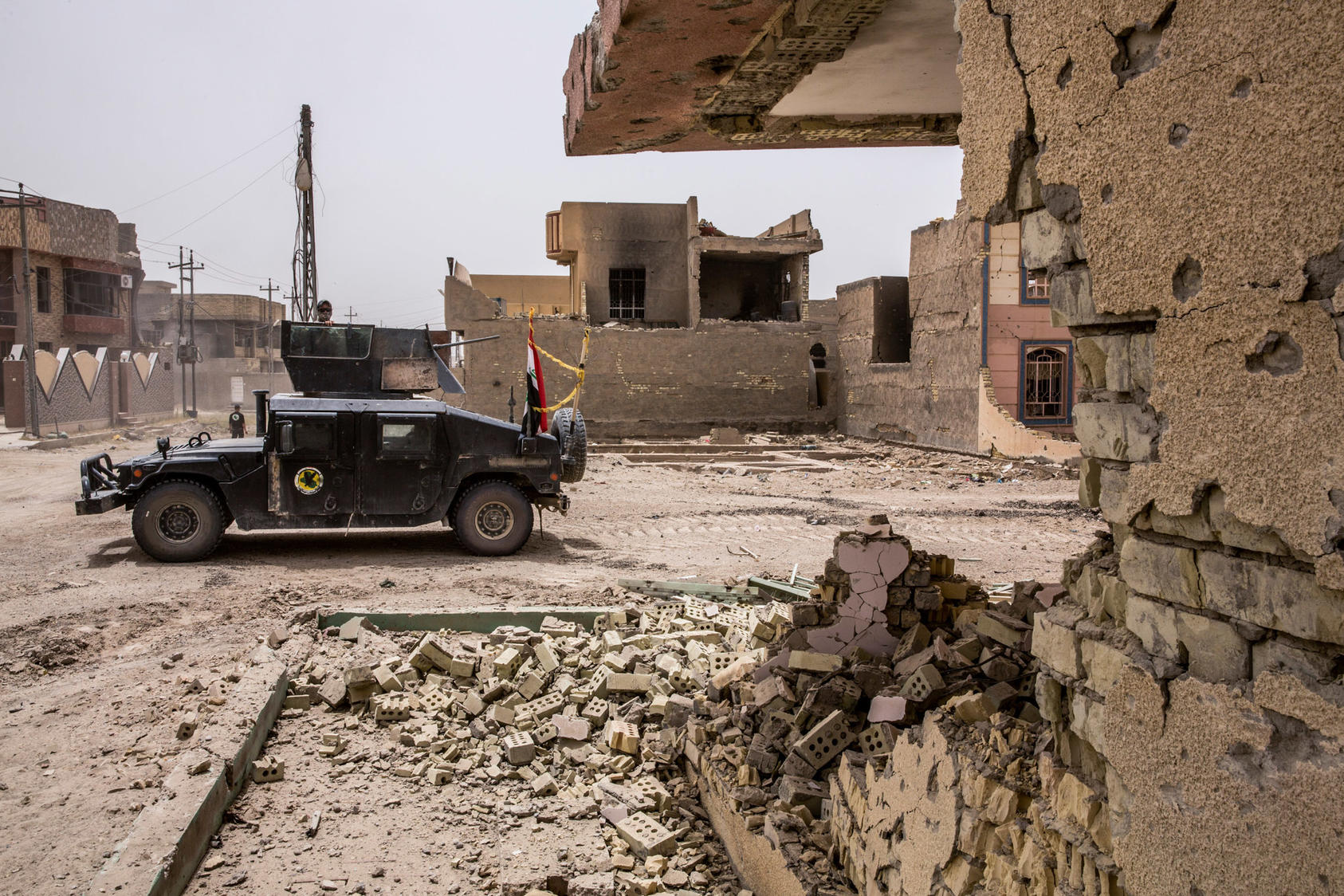 Iraqi counterterrorism forces move through the heavily damaged Shuhada neighborhood in Fallujah, Iraq, June 18, 2016. The Islamic State’s suicide attack in Baghdad in July, officials say, foreshadows the violence it will unleash as it reverts to its guerrilla roots. A return to guerrilla warfare in Iraq, while the United States and its allies still combat the Islamic State in Syria, would pose one of the first major challenges to the next American president. (Bryan Denton/The New York Times)