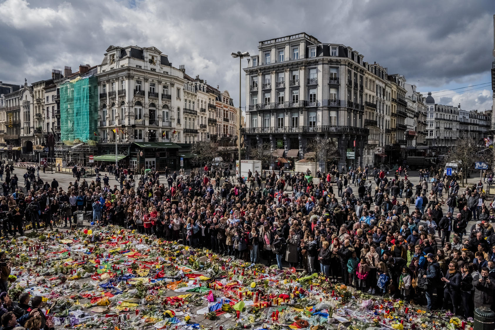 People gather around a makeshift memorial for victims of Tuesday's attacks, during a peace rally in Brussels, March 27, 2016