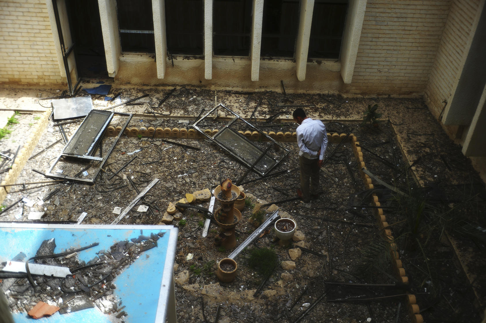 A man in a damaged courtyard at the provincial council headquarters after terrorists attacked the building last Tuesday in Tikrit, Iraq, April 3, 2011. Nearly 60 died and more than 90 were wounded in last Tuesday’s brazen attack, which turned into a hostage standoff until Iraqi security forces retook the building. 