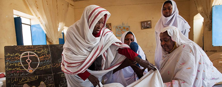 El Fasher: (Furthest left and furthest right) Teachers Nephisa Ahmed and Hawa Osmani show (center left to right) students Ihlas Mohamed and Manahil Adam how to assist a delivery at the lab of the Midwifery School in El Fasher, North Darfur. Teachers and students of this center recently signed a pledge to stop the practice of female genital mutilation in Darfur.  Photo by Albert Gonzalez Farran, UNAMID.