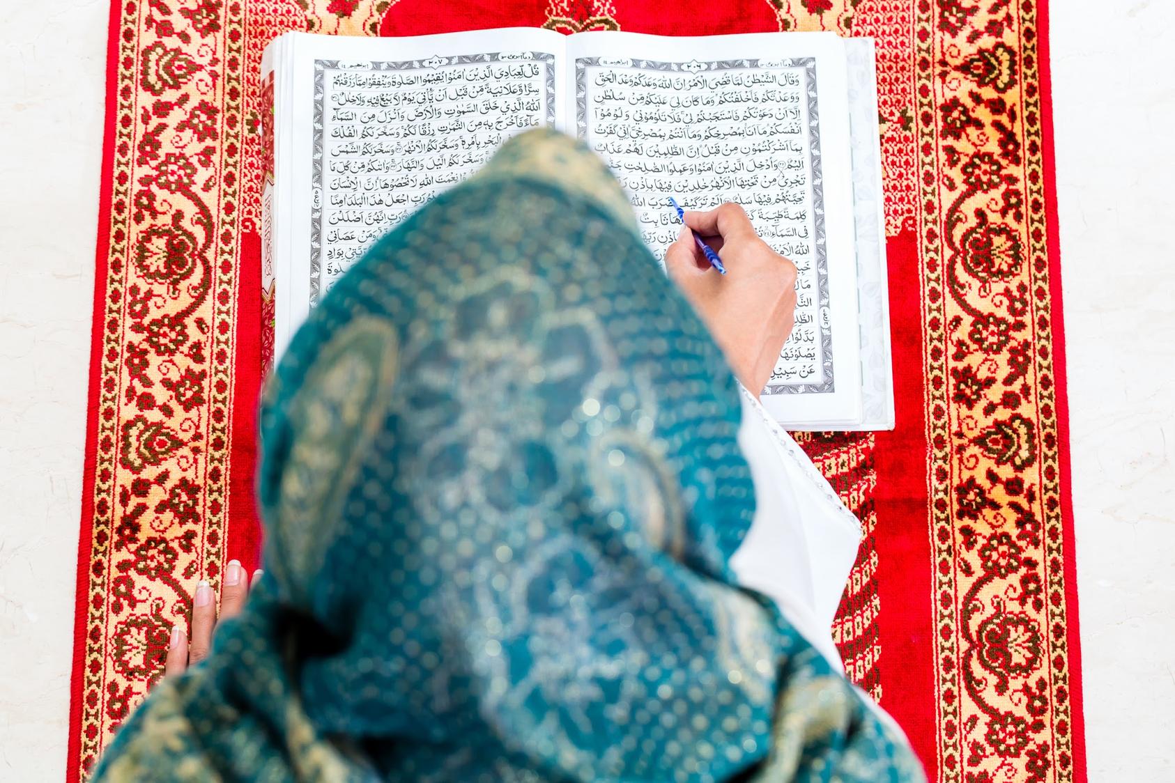 Muslim woman reading Koran