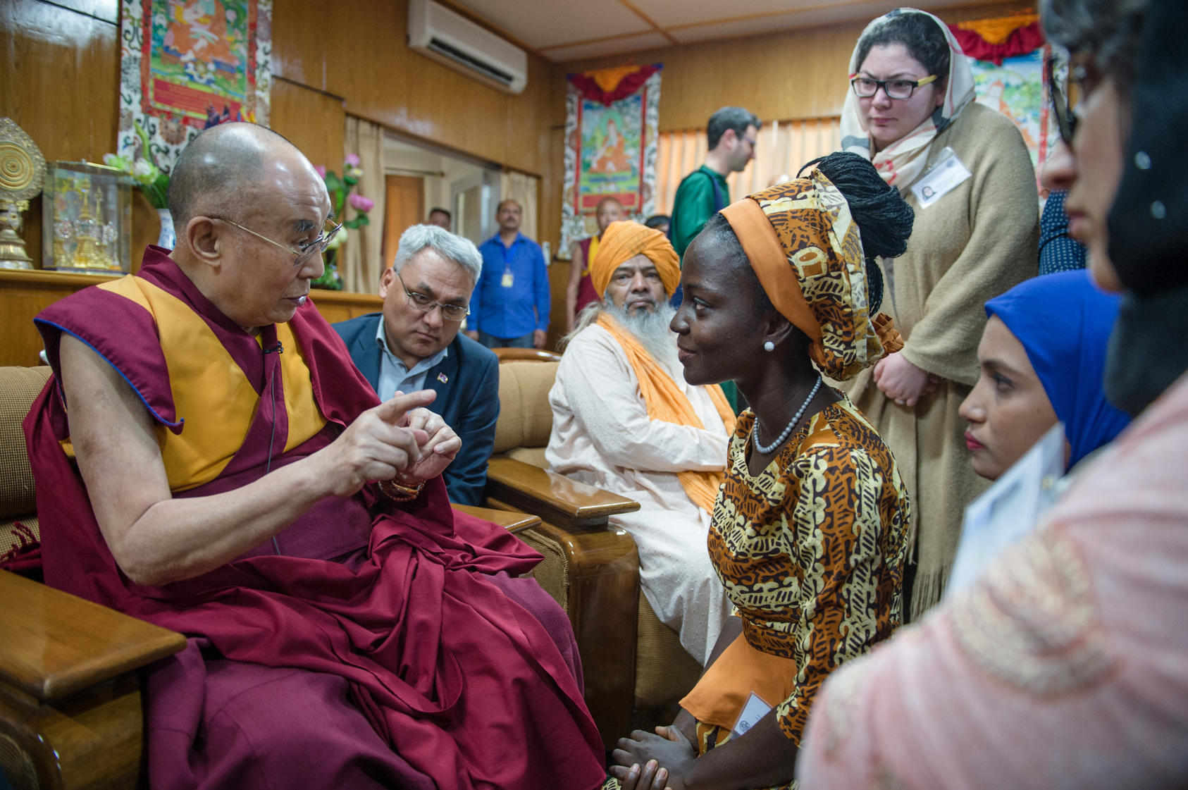 His Holiness the Dalai Lama serves cookies to young peace leaders during meetings with them at his residence in Dharamsala, India. Photo: Tenzin Choejor/OHHDL