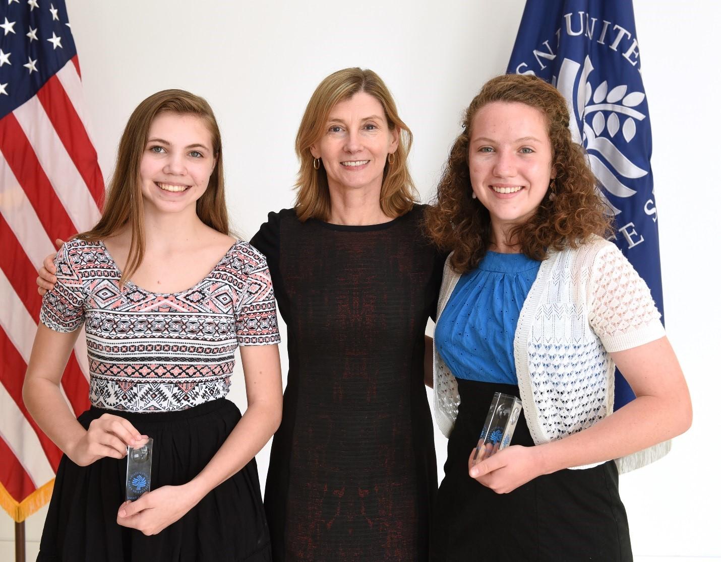 National History Day 2015 USIP Special Award Junior Division winner Kailyn Noble (left) and Senior Division winner Marie Laverdiere (right) with President Nancy Lindborg