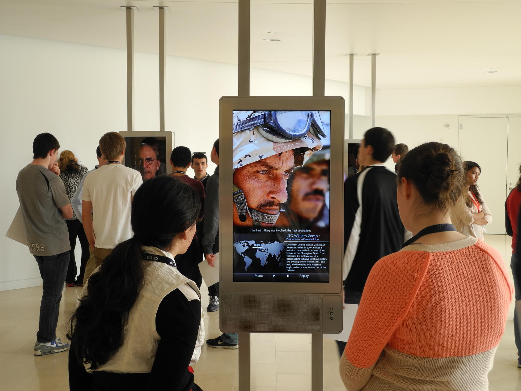 Students view the Witnesses to Peacebuilding exhibit at USIP. 
