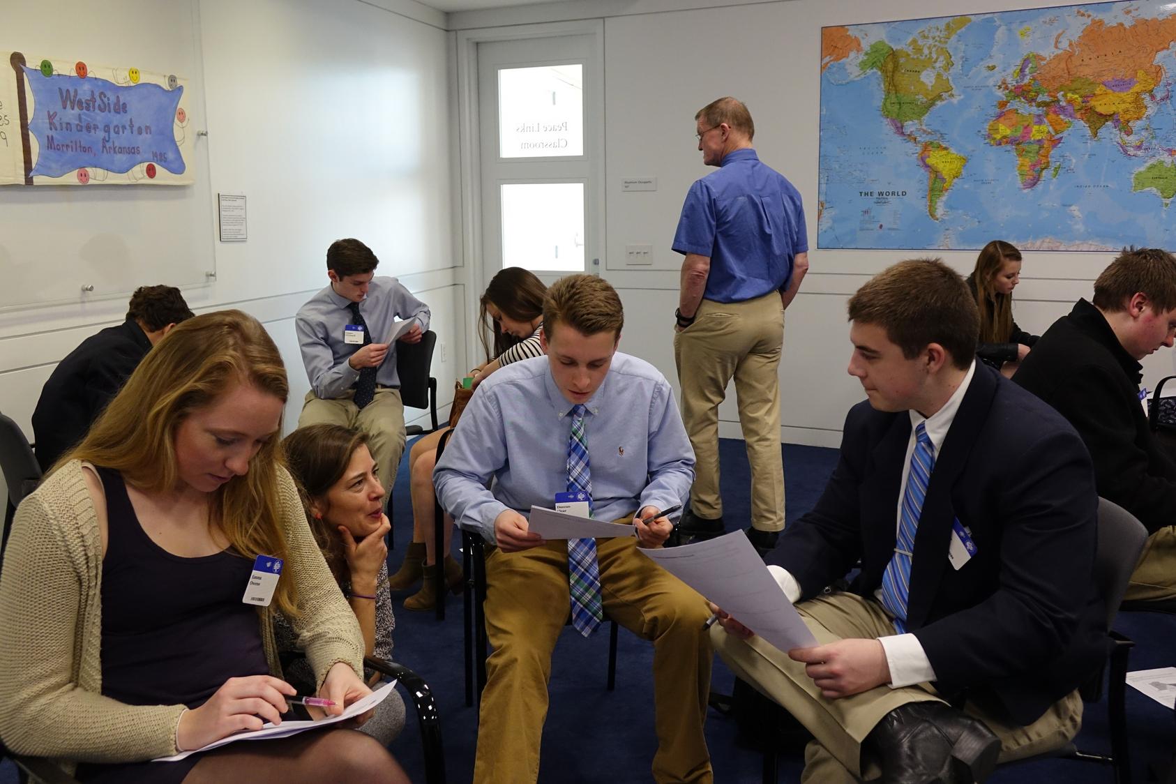 Amanda Terwillegar helps her students prepare for a simulation during a workshop at the U.S. Institute of Peace.