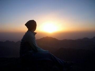 Abigail enjoying the view of a sunrise from Mount Sinai, a site of religious and cultural significance. 