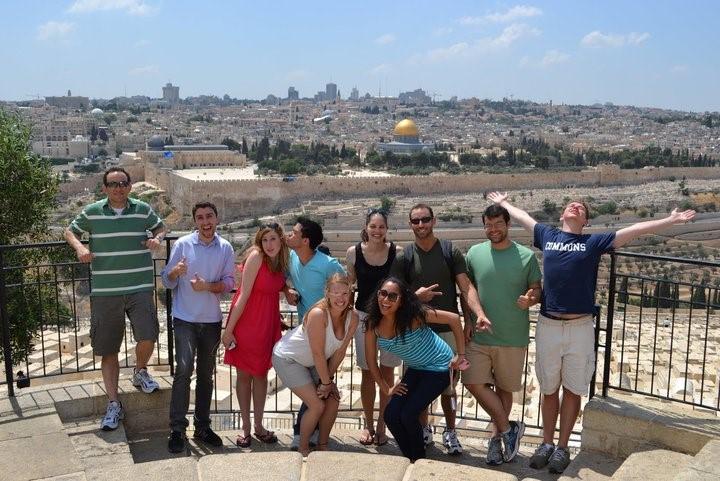 Students studying abroad in Israel on the side of a mountain overlooking Jerusalem's iconic Dome of the Rock.
